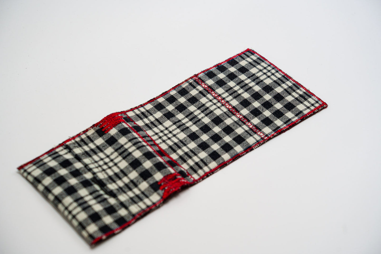 Black and pale-olive plaid exterior of a one-of-a-kind wallet, laid flat — HighSew