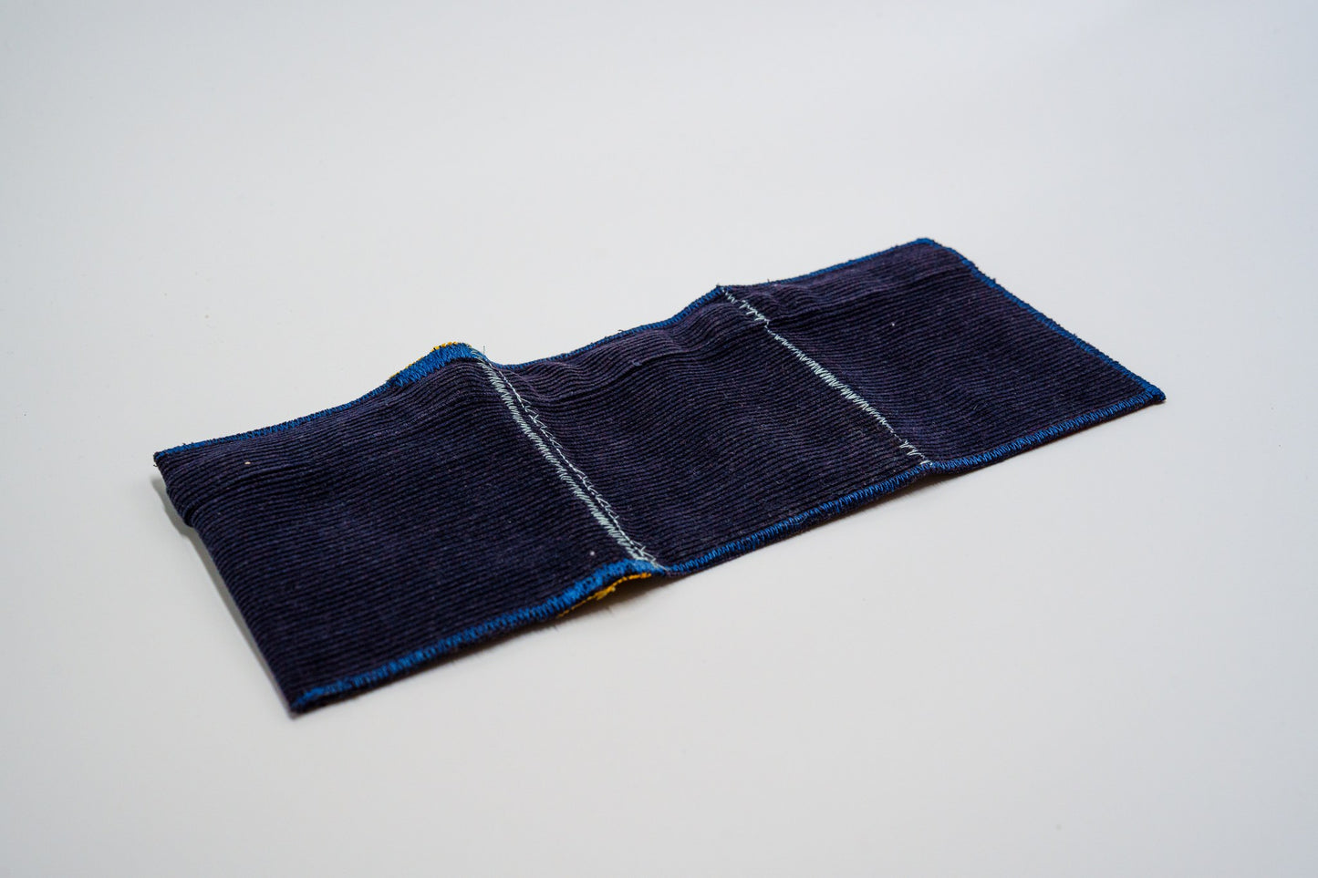Deep blue corduroy exterior laid flat, zigzag-stitched edges — HighSew
