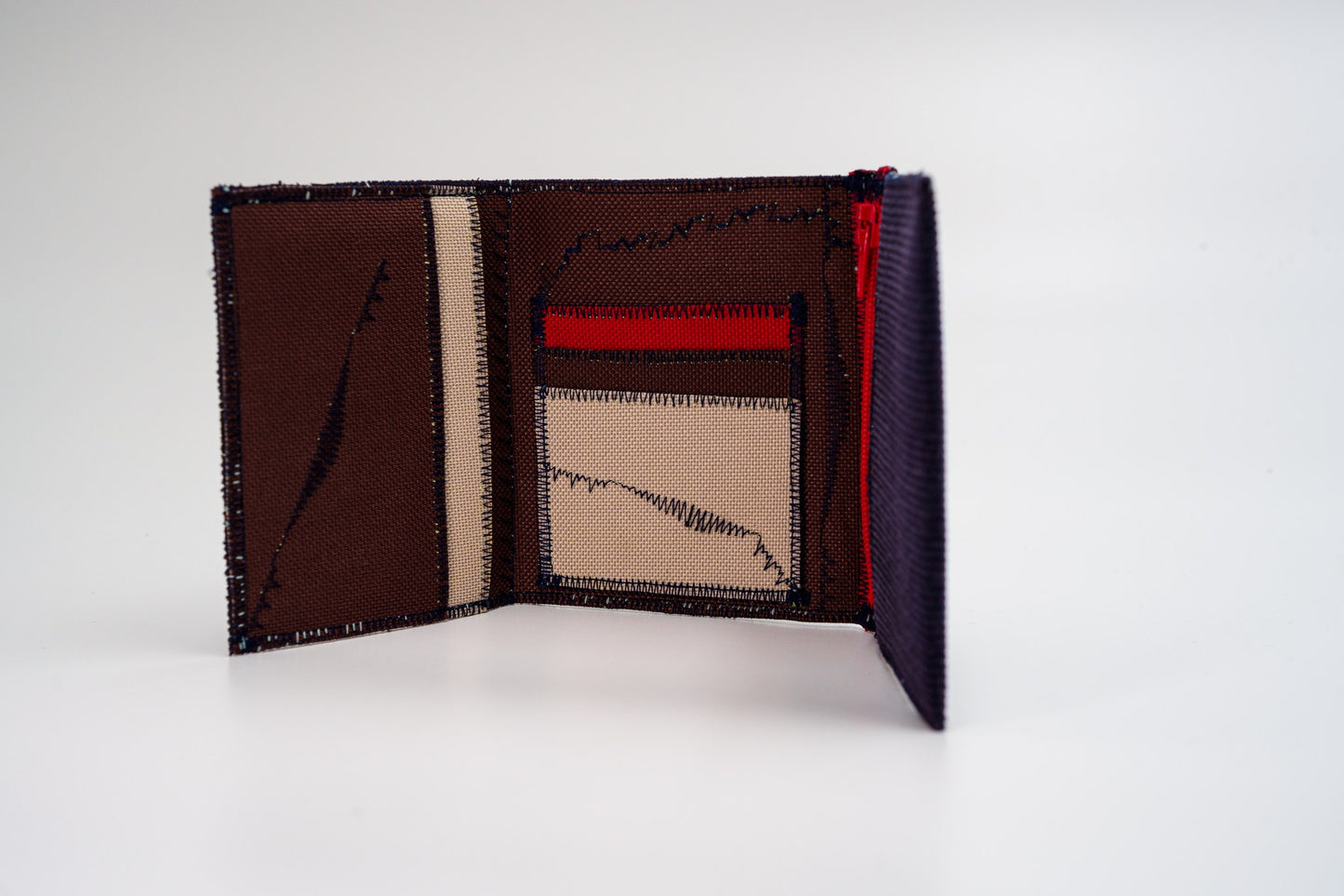 Corduroy wallet standing open, showing brown and sand interior with red zip — HighSew