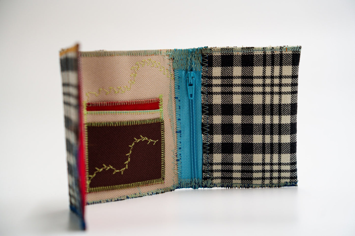 Upcycled flannel wallet standing open, plaid exterior meeting colorful interior — HighSew