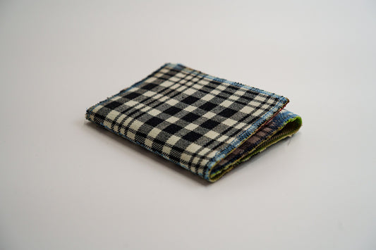 Black and pale-olive plaid wallet closed at an angle, handmade from an upcycled flannel shirt — HighSew