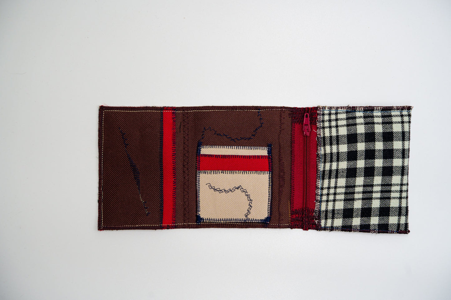Open wallet interior with warm brown and sand card slots, navy zigzag stitching and a burgundy zip — HighSew