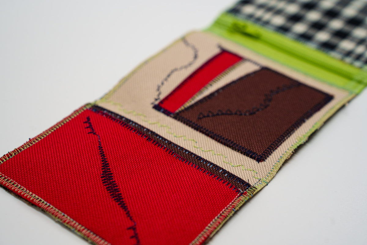 Close-up of red wallet interior with the brand signature stitch in navy, from an upcycled flannel shirt — HighSew