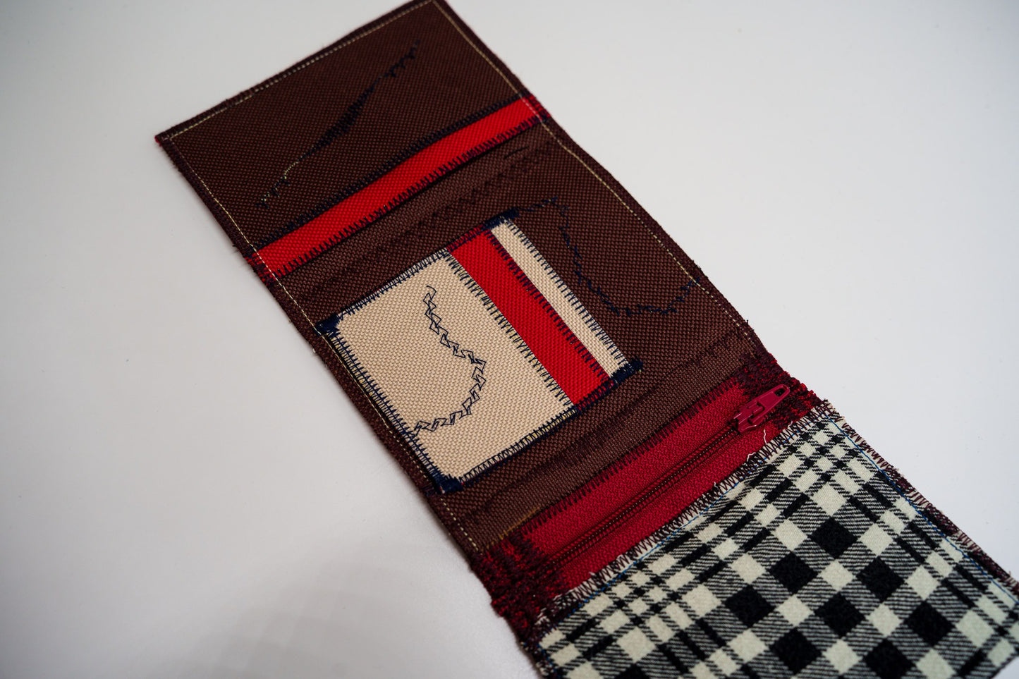 Close-up of the wallet interior, sand-toned card slot with navy zigzag stitching and deep red within — HighSew