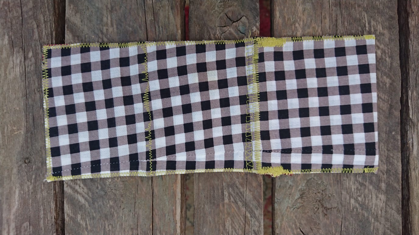 A one-of-a-kind wallet called "Black, Grey and White" is made by Highsew. It is made of recycled shirt fabric combined with new, strong fabric. Outside view.