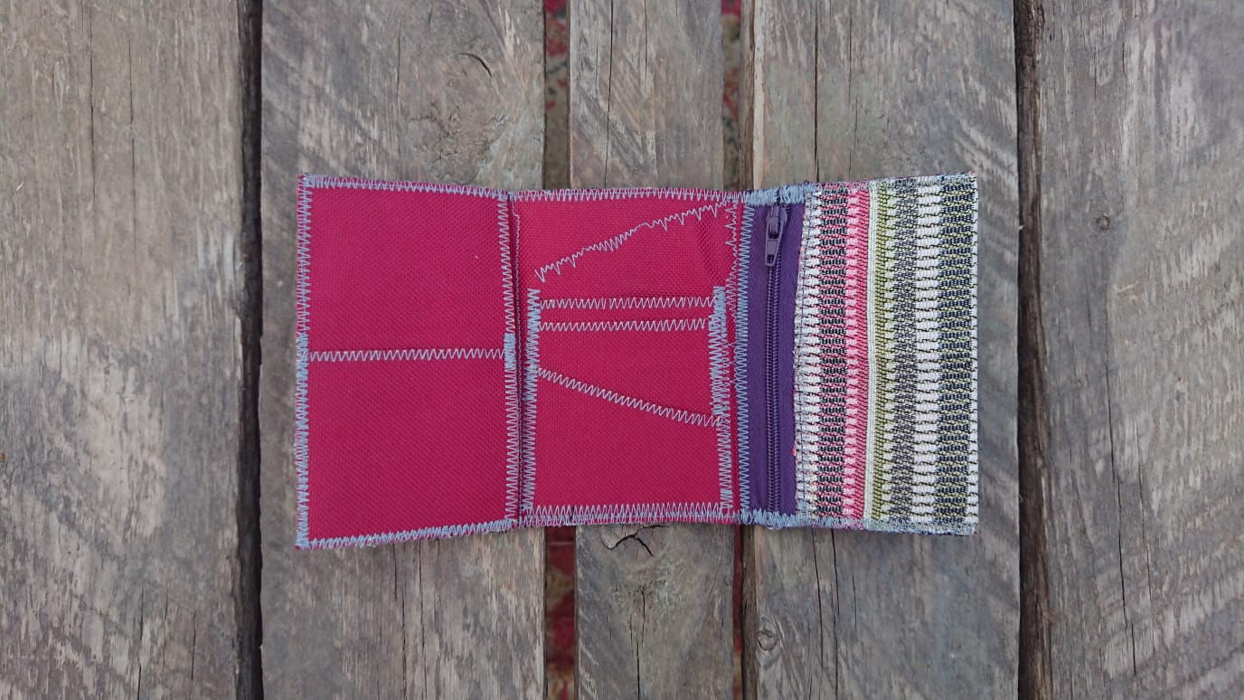 A one-of-a-kind wallet called "Blurred Lines" is made by Highsew. It is made of recycled fabric combined with new, strong fabric. Inside view.