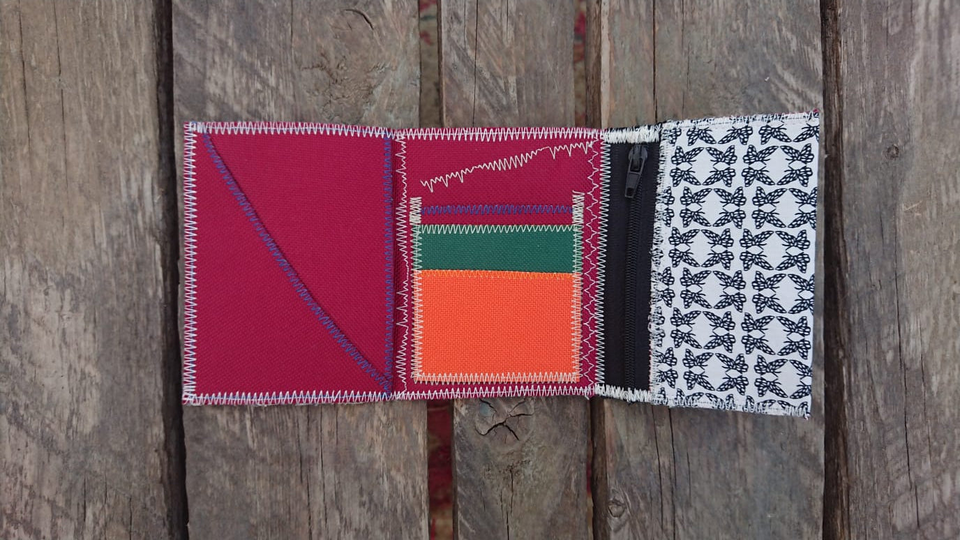 A one-of-a-kind wallet called "Butterflies Holding Hands" is made by Highsew. It is made of recycled shirt fabric combined with new, strong fabric. Inside colorful view of the wallet 