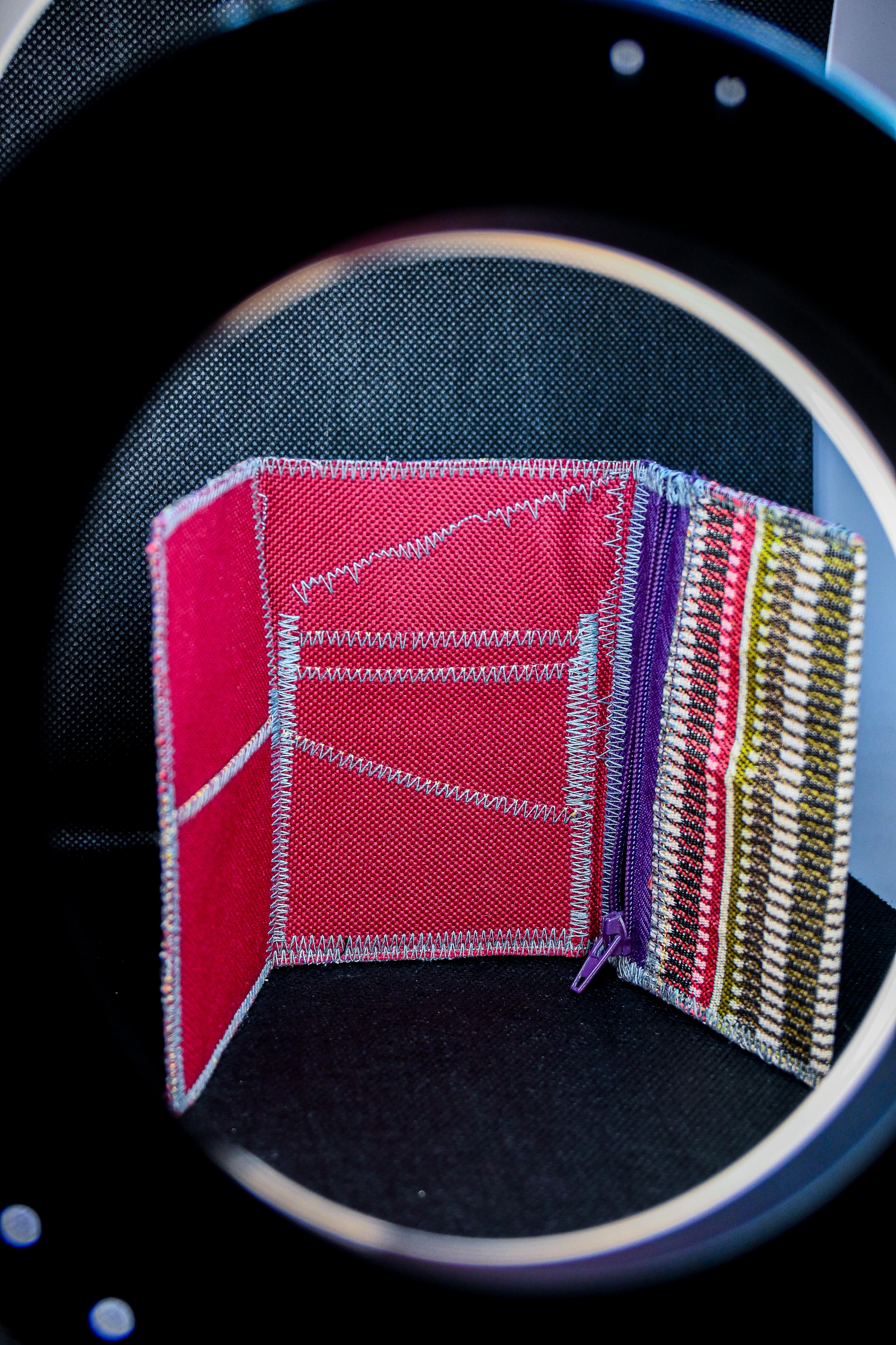 A one-of-a-kind wallet called "Blurred Lines" is made by Highsew. It is made of recycled fabric combined with new, strong fabric. It is really colorful and cool.