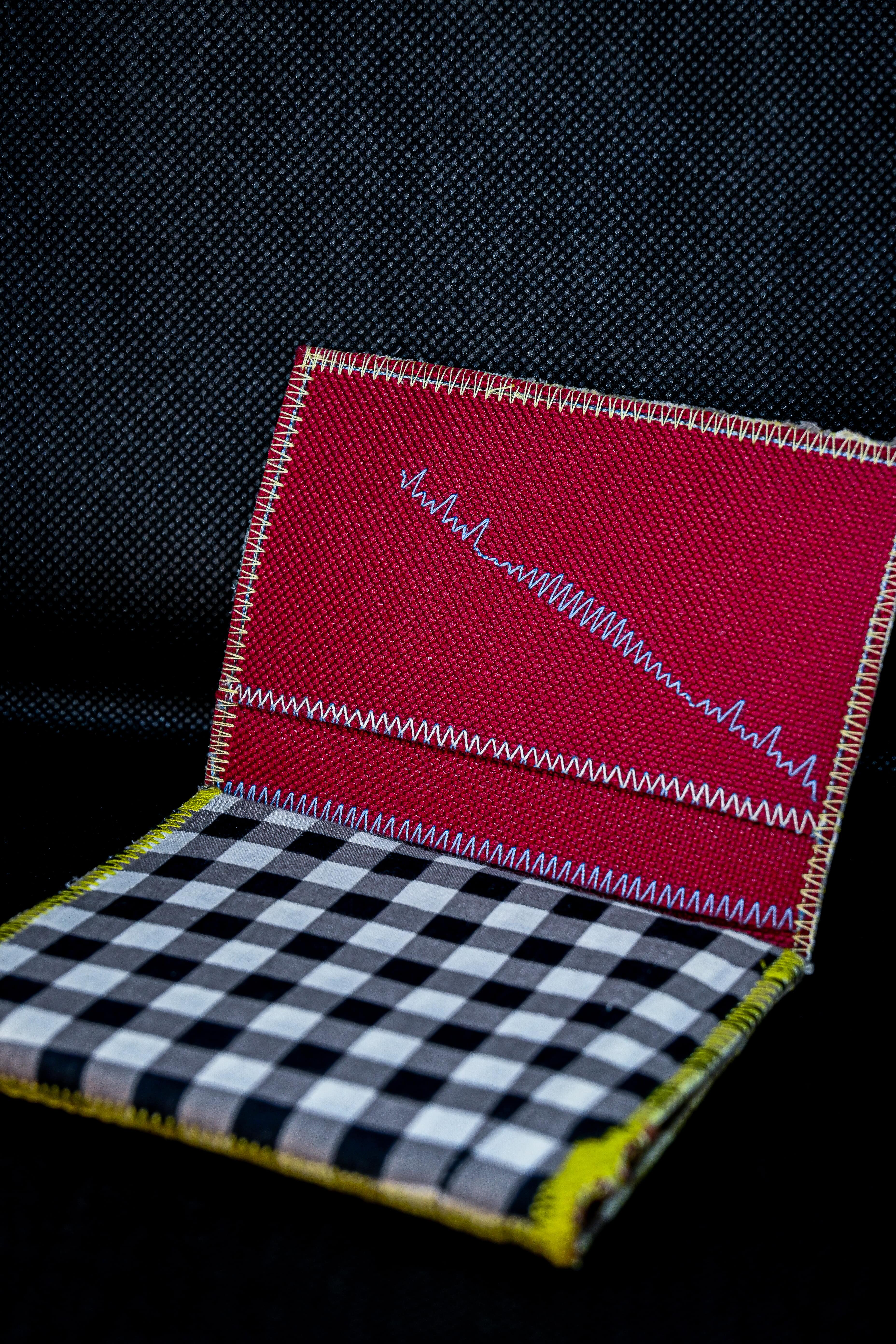 A one-of-a-kind wallet called "Black, Grey and White" was made by Highsew. It is made of recycled fabric combined with new, strong fabric. It is really colorful and cool.