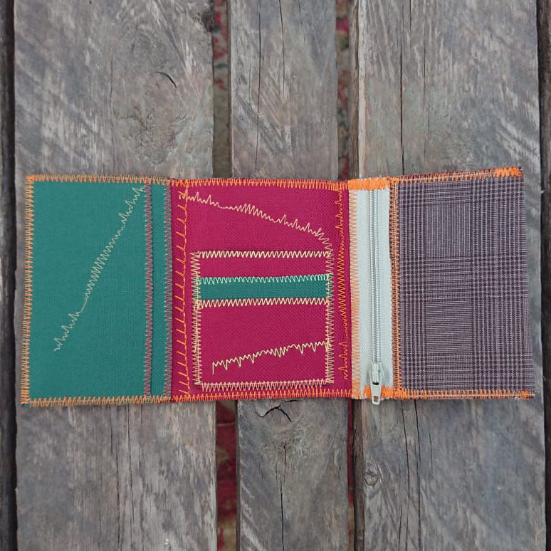 A one-of-a-kind wallet called "Drink & Evening" is made by Highsew. It is made of recycled old pants fabric combined with new, strong fabric. Inside view.