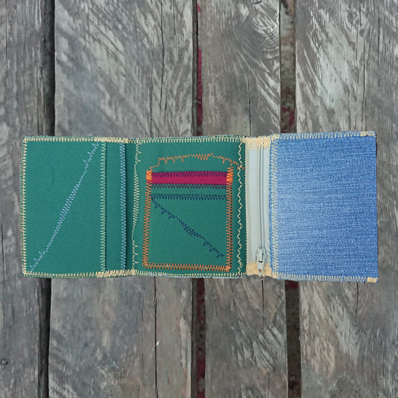 A one-of-a-kind wallet called "Purple Green Stitch Jeans" is made by Highsew. It is made of recycled jeans fabric combined with new, strong fabric.