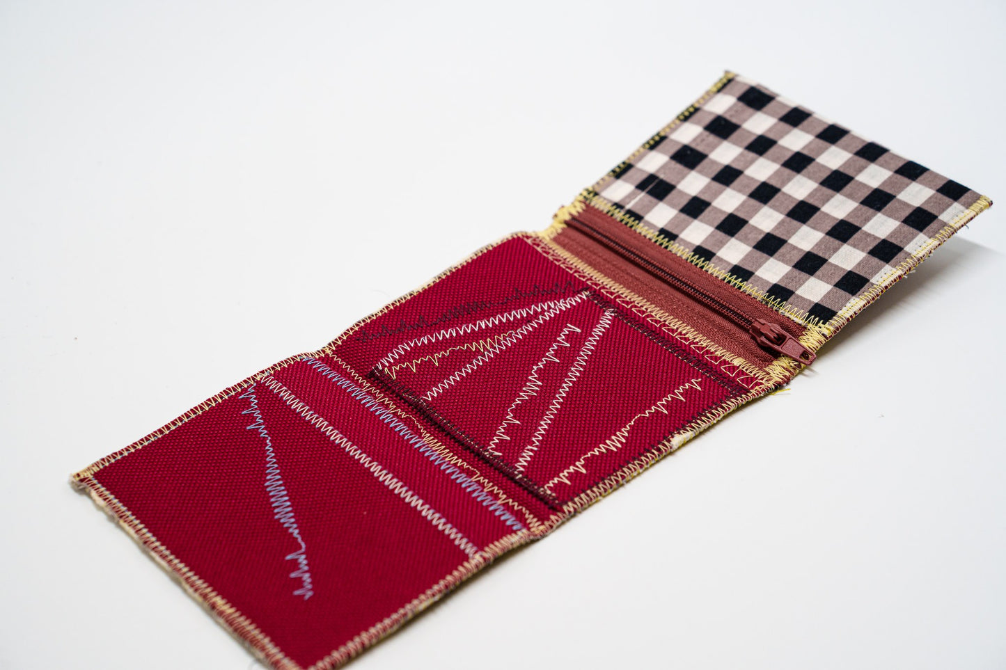Open wallet interior in deep red with colored zigzag stitching and zip pocket — HighSew