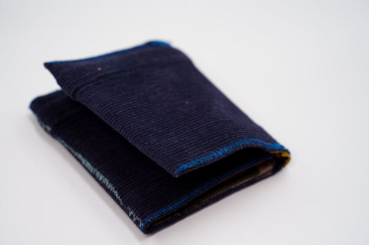 Deep blue corduroy wallet, closed at an angle, handmade from upcycled trousers — HighSew