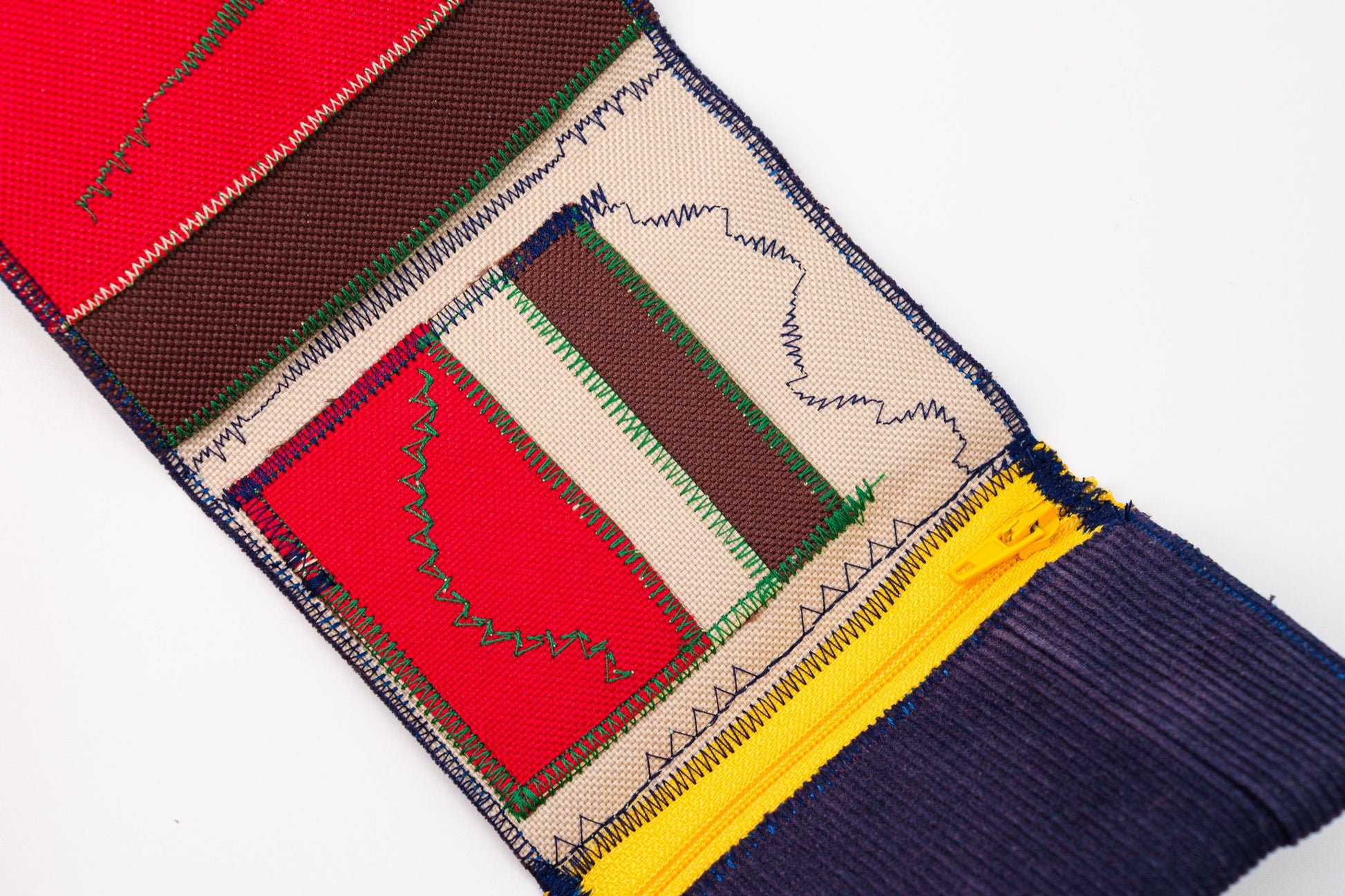 Close-up of wallet interior — red and brown Cordura card slots with green signature stitch — HighSew