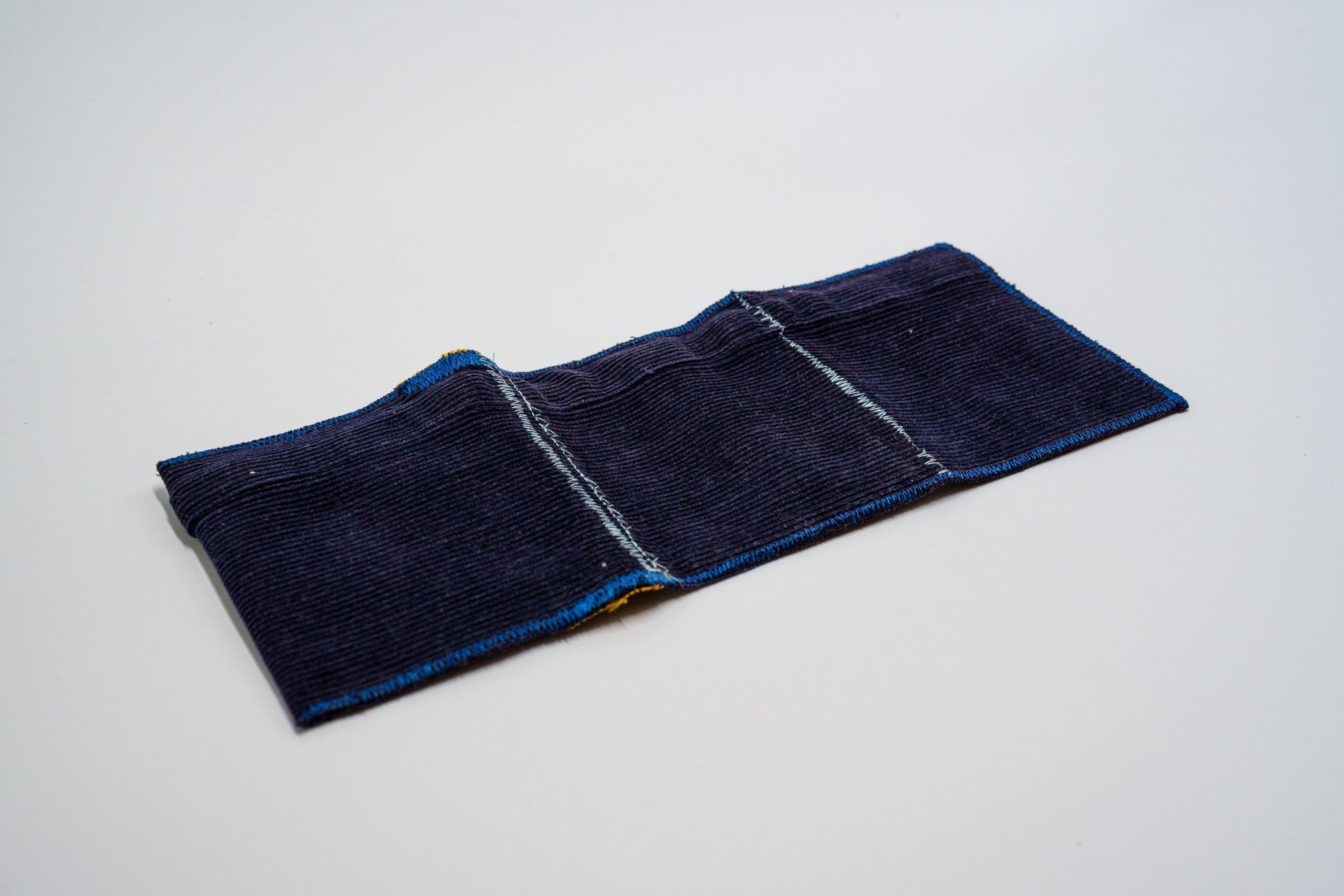 Deep blue corduroy exterior laid flat, zigzag-stitched edges — HighSew