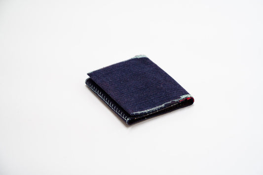 Deep blue corduroy wallet, closed at an angle, handmade from upcycled trousers — HighSew