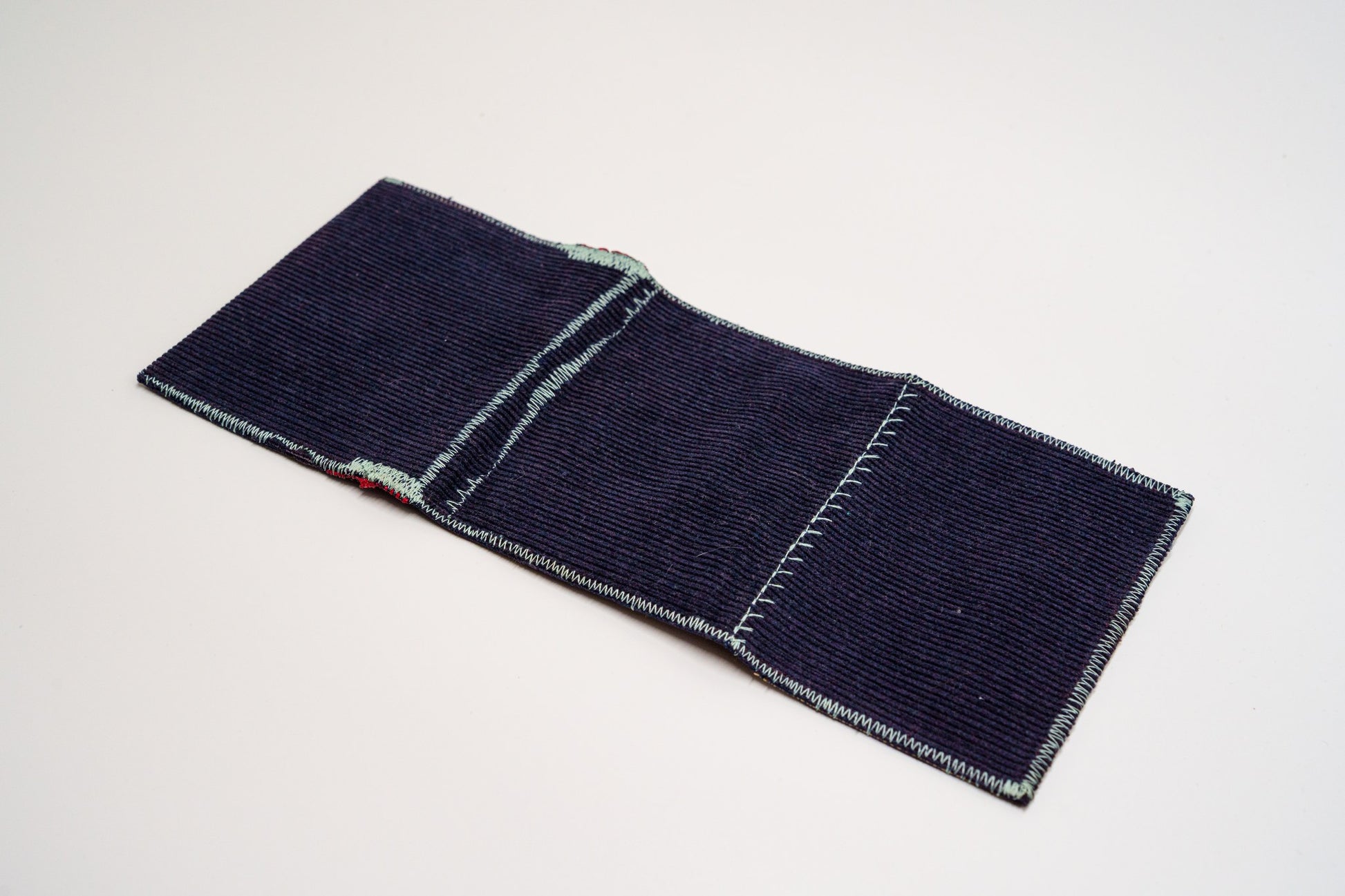 Deep blue corduroy exterior laid flat, zigzag-stitched edges — HighSew