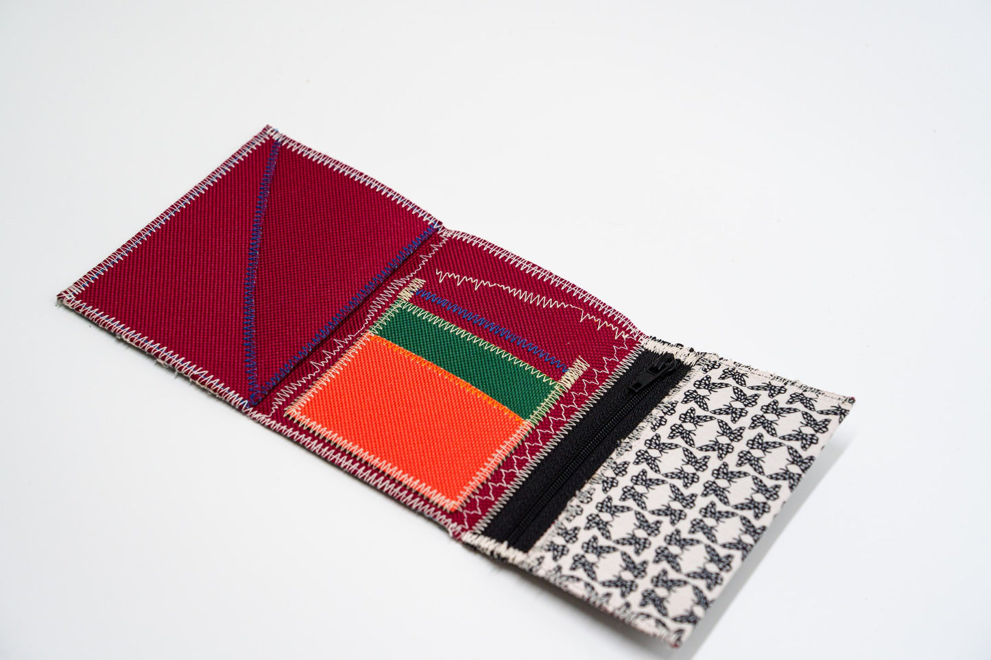 Open wallet interior in deep red with neon orange and green card slots and black zip — HighSew