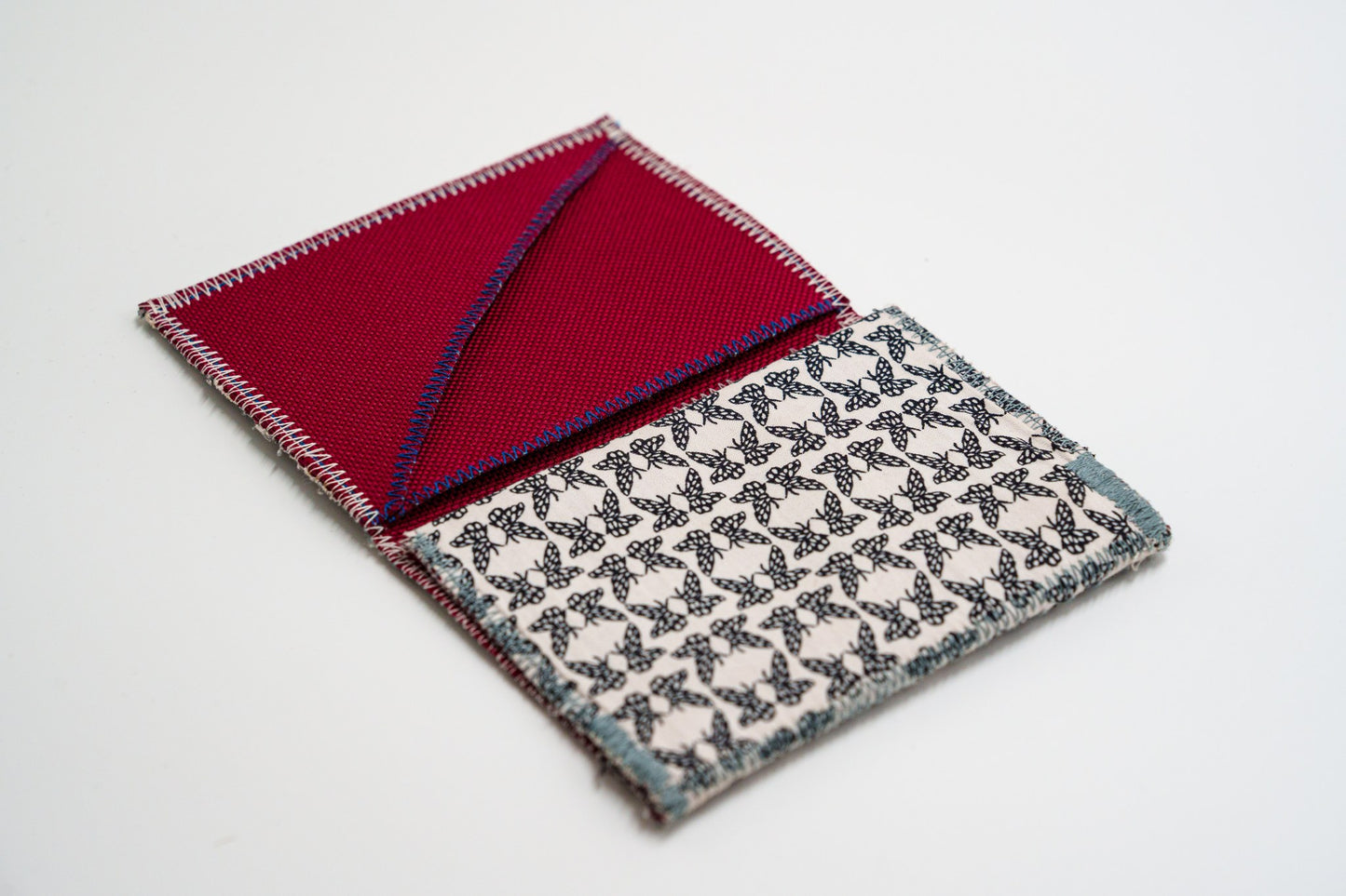 Butterfly-print wallet open at an angle showing red interior — HighSew