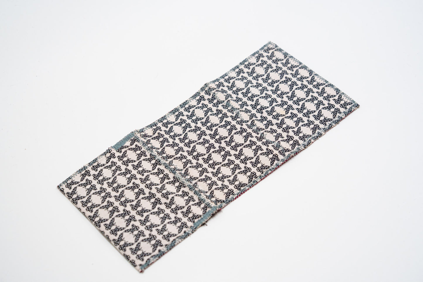 Cream and black butterfly-print exterior of one-of-a-kind upcycled wallet — HighSew