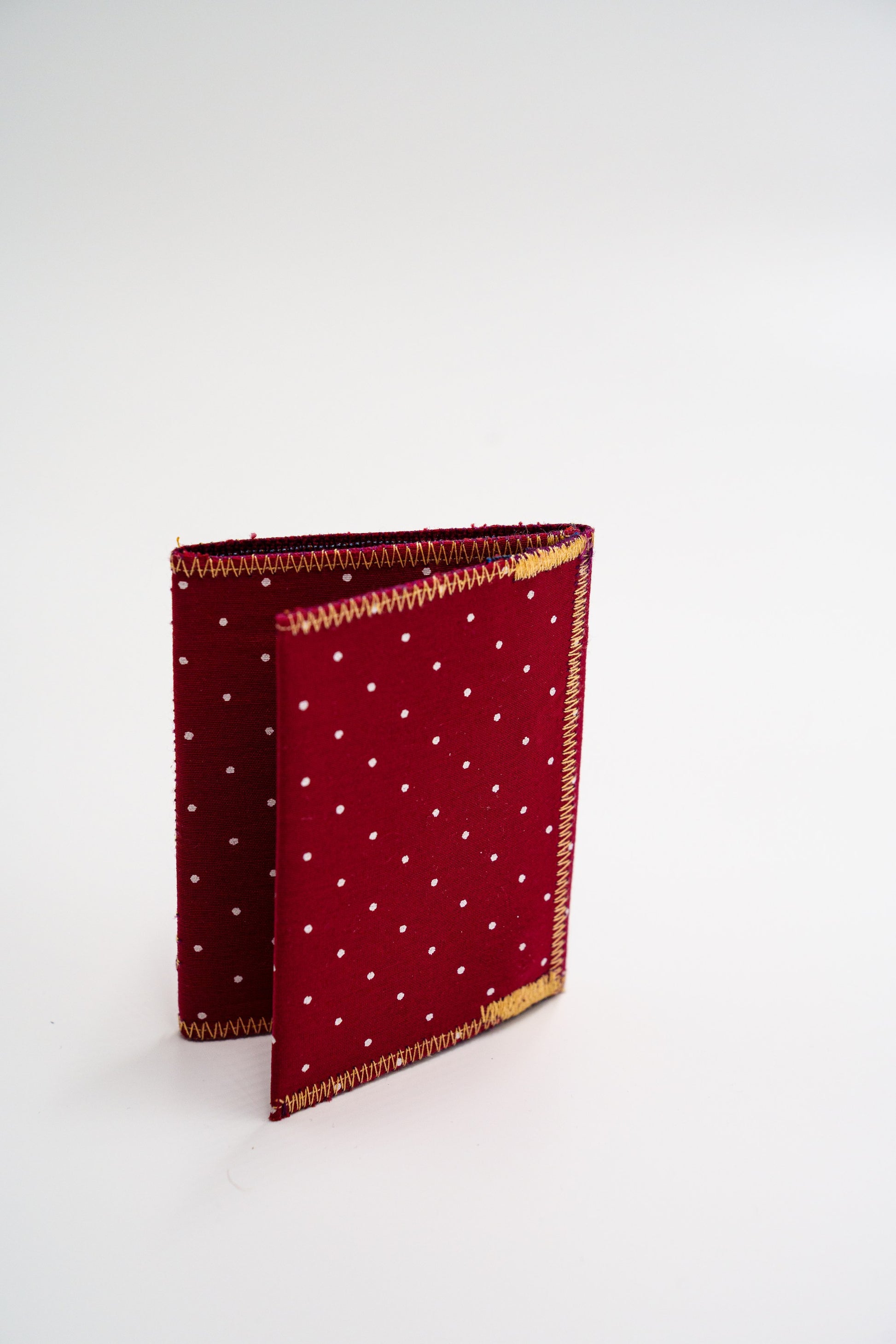 Upcycled red polka-dot wallet standing folded — HighSew