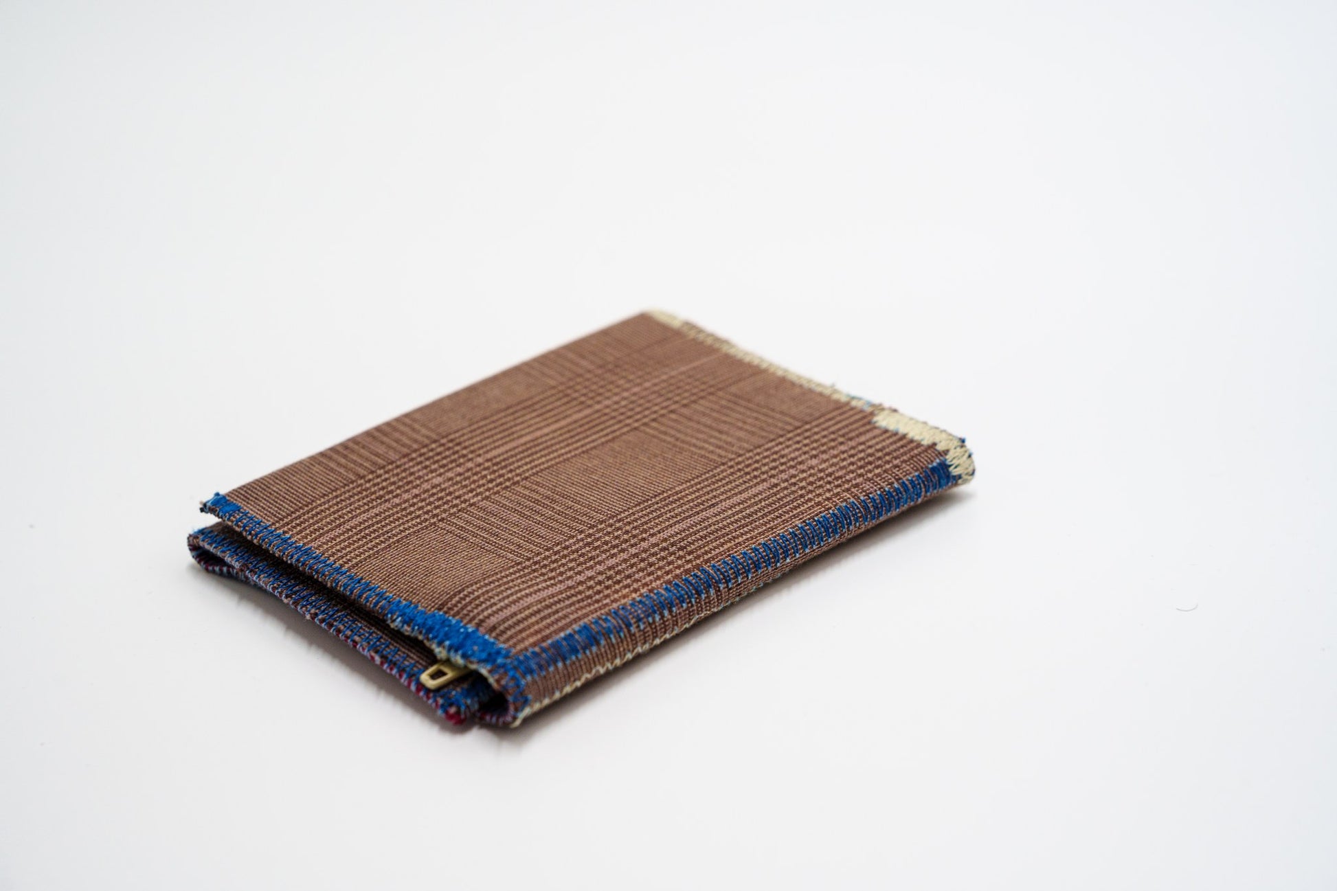 Brown glen-plaid wallet closed at an angle, handmade from upcycled trousers — HighSew