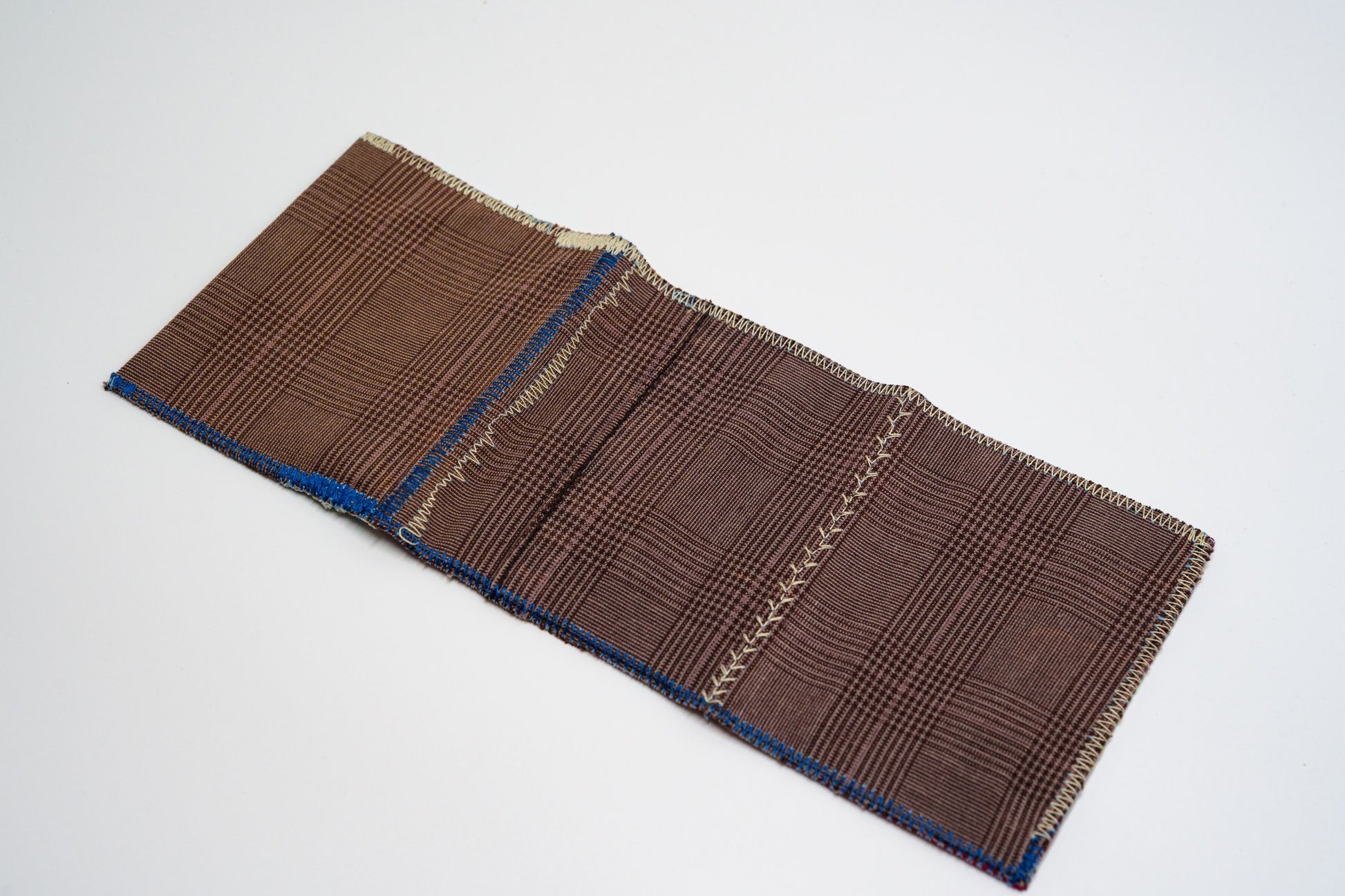 Brown glen-plaid exterior of a one-of-a-kind wallet, laid flat — HighSew