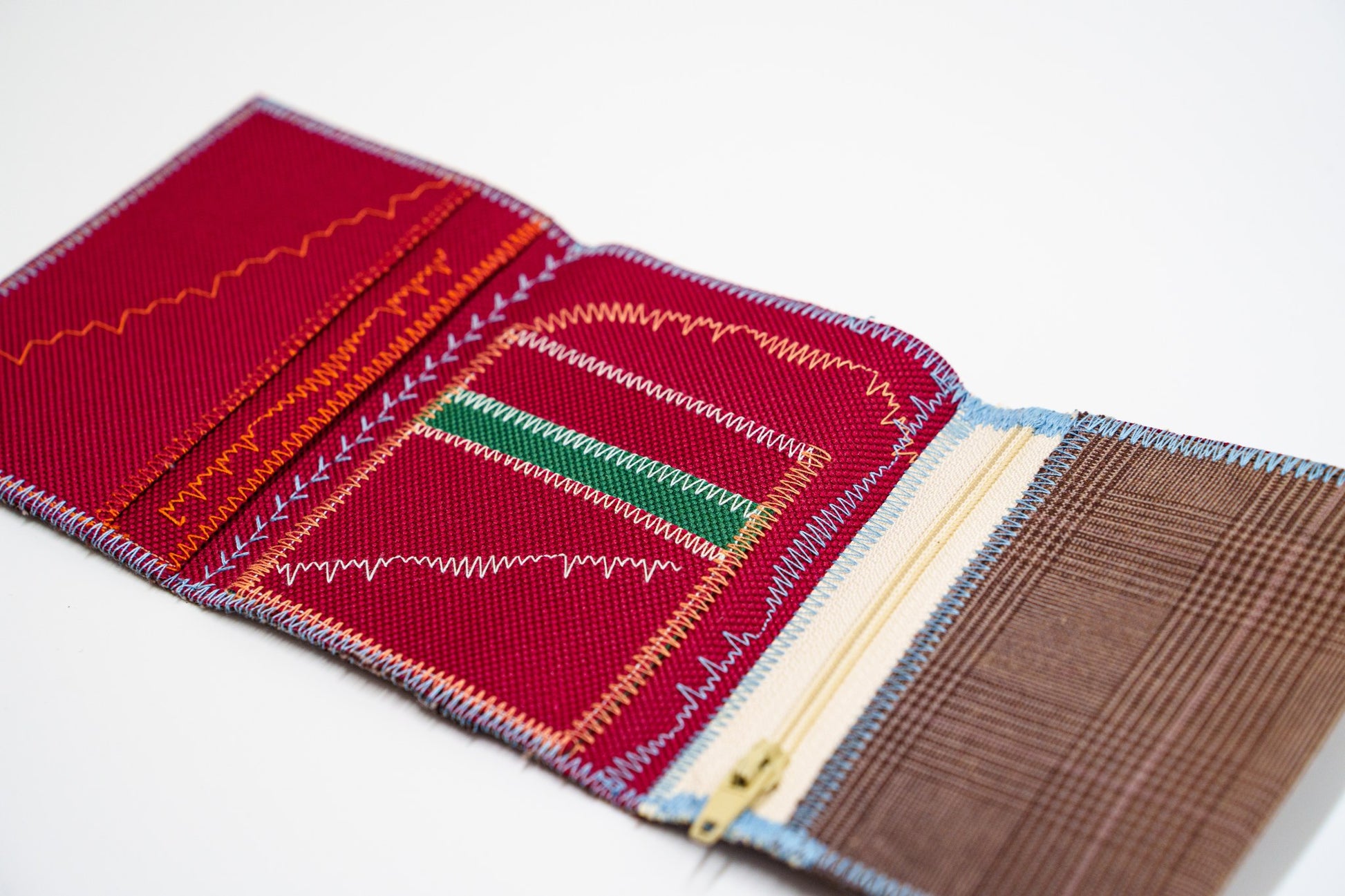 Close-up of red wallet interior with green panel and gold zip — HighSew