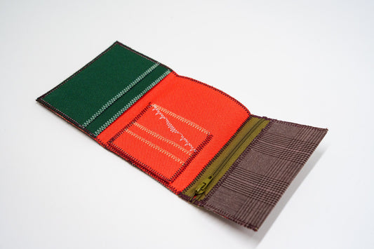 Open wallet interior with orange-red and green panels, colored zigzag stitching — HighSew