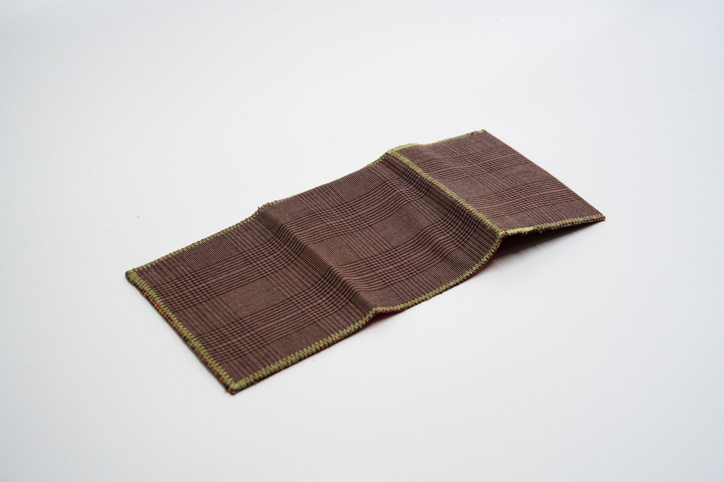 Brown glen-plaid exterior of a one-of-a-kind wallet, laid flat — HighSew