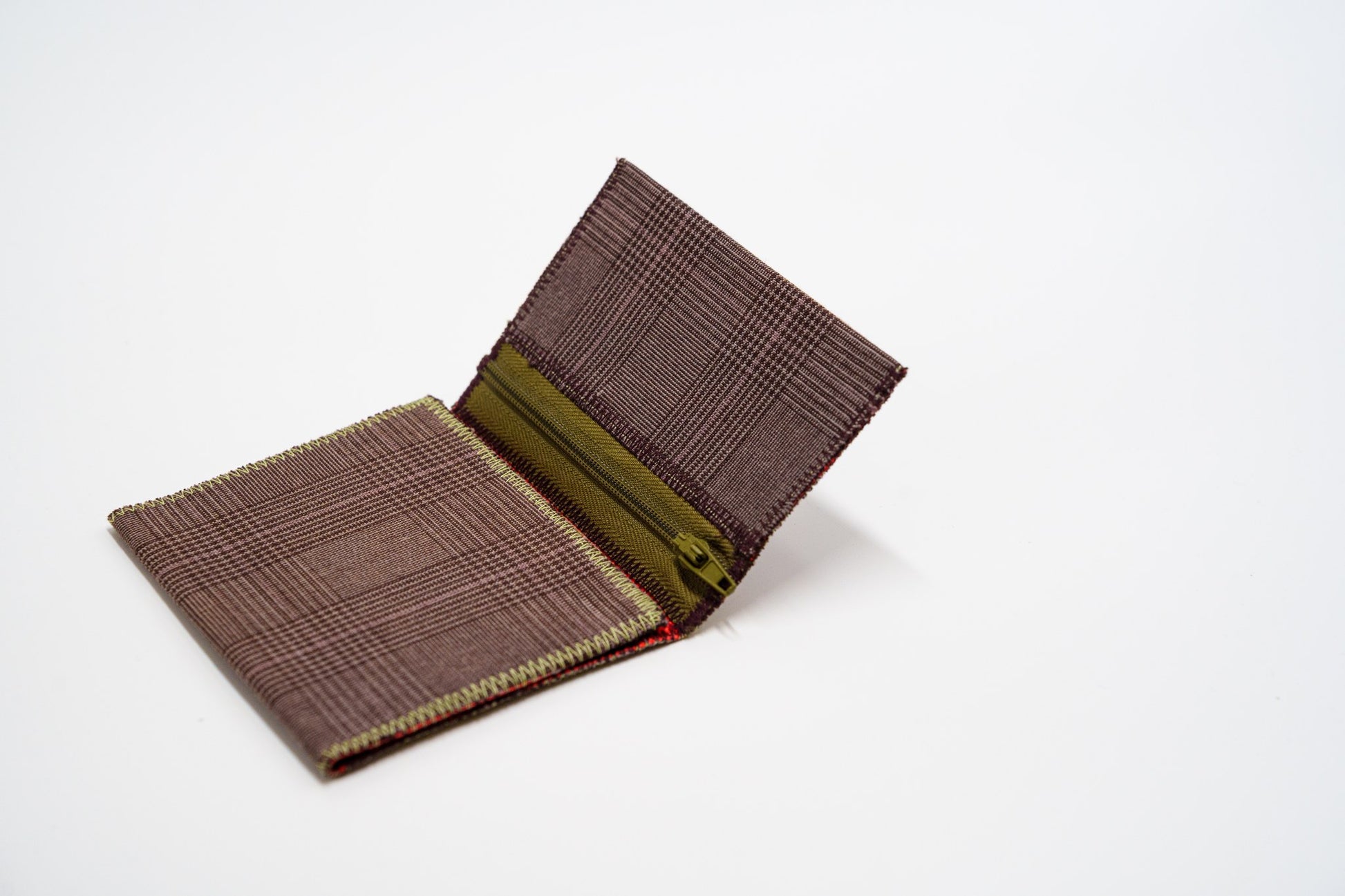 Upcycled wallet half open, brown exterior meeting colorful interior — HighSew