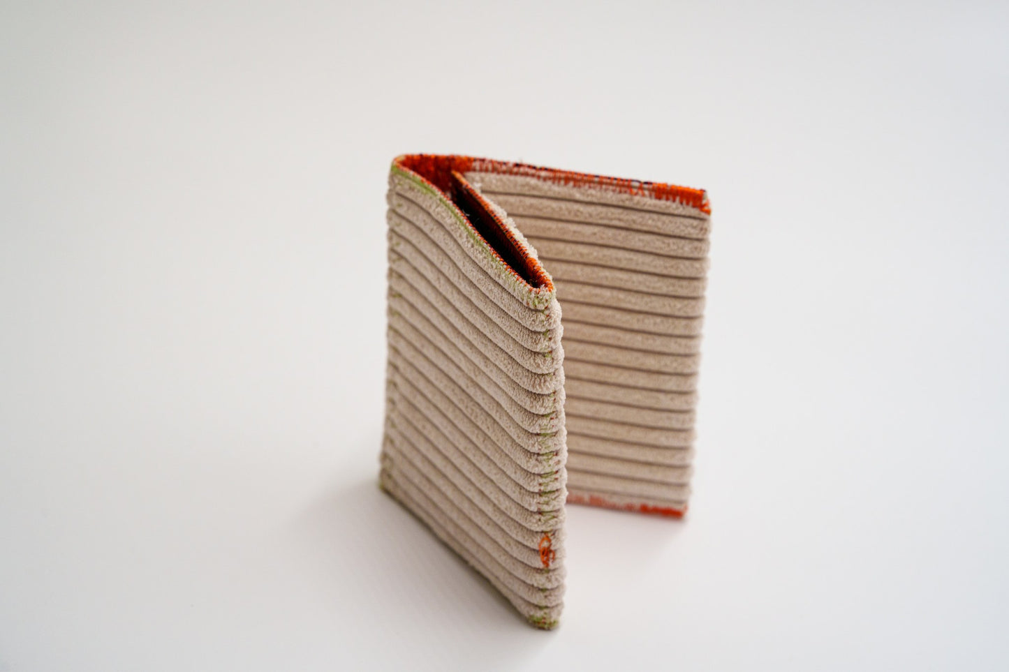 Upcycled cream ribbed wallet standing folded — HighSew