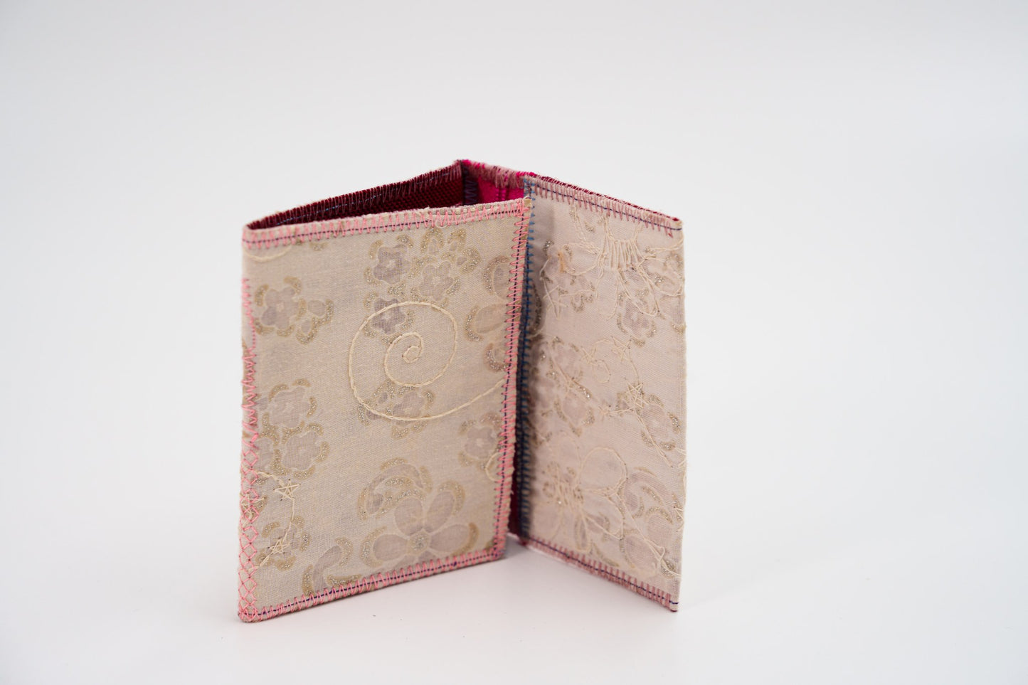 Cream floral wallet standing folded, one-of-a-kind upcycled piece — HighSew