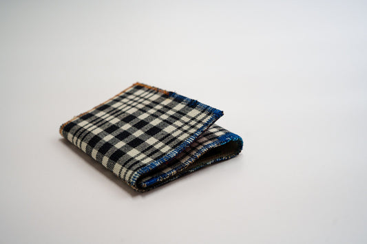 Black and pale-green plaid wallet closed at an angle, handmade from an upcycled flannel shirt — HighSew