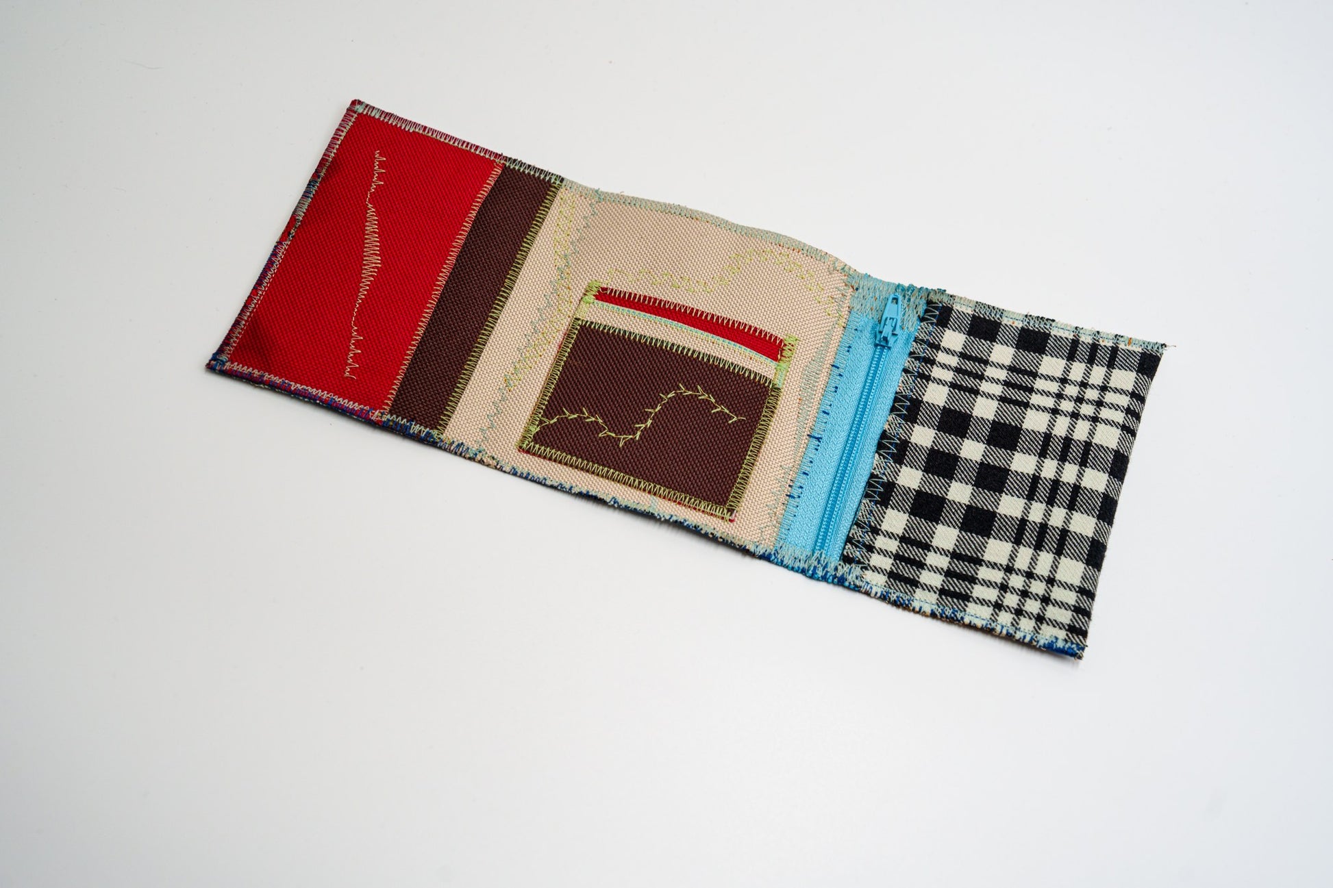 Open wallet interior with red, brown and beige panels, colored stitching and light-blue zip — HighSew