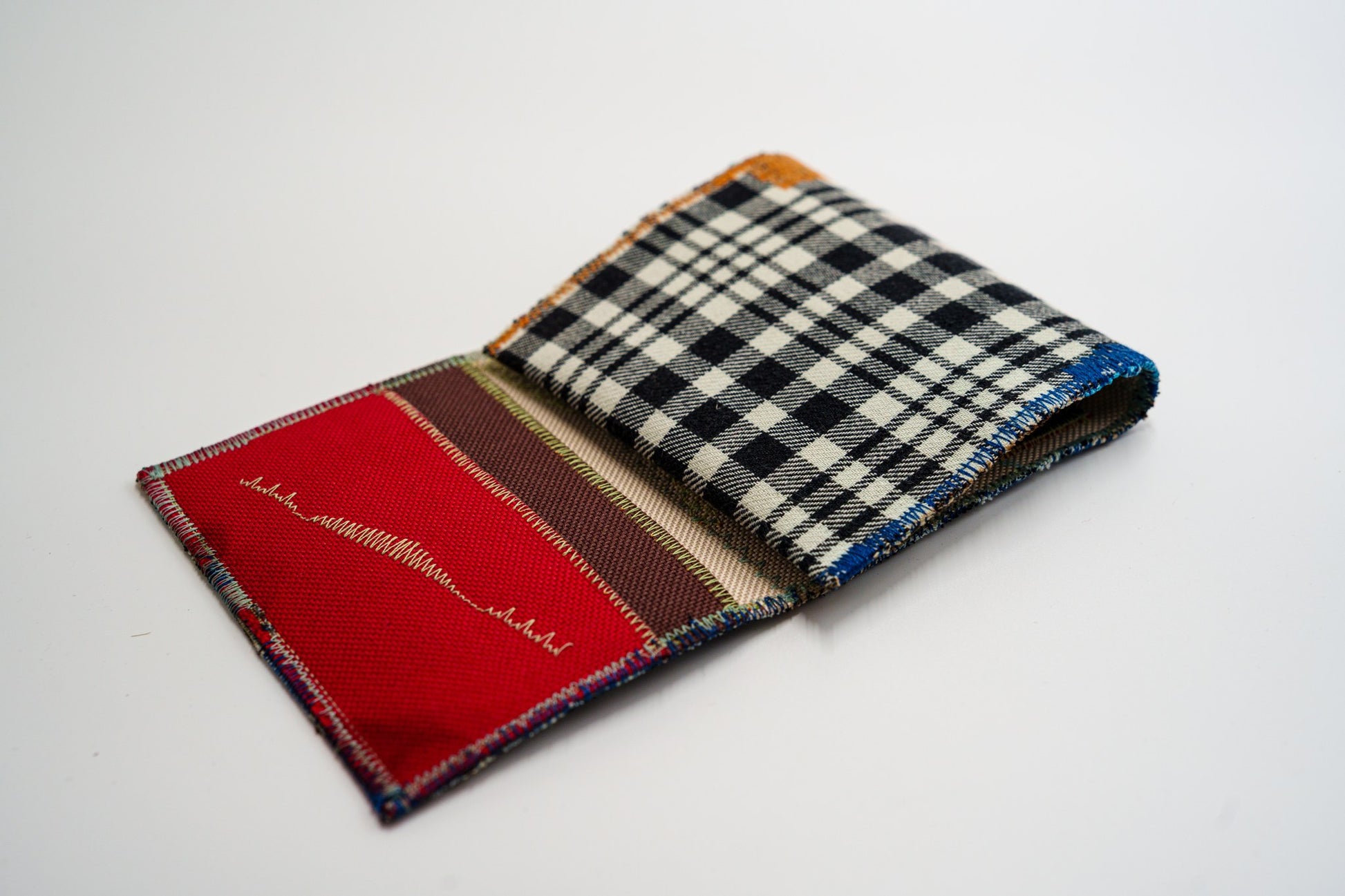 Close-up of red wallet interior with zigzag stitching, from an upcycled flannel shirt — HighSew