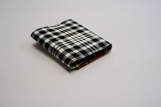 Black and pale-olive plaid wallet closed at an angle, handmade from an upcycled flannel shirt — HighSew